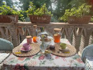 a table with a table cloth with cups and tea cups at Casale la Civetta in Larino