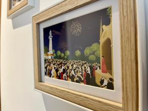 a framed picture of a crowd of people with fireworks at Suite Clovis 2 in Reims +2 photos