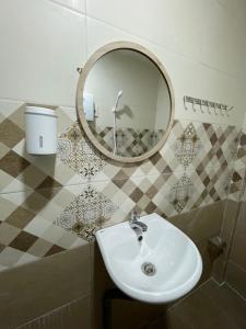 a bathroom with a sink and a mirror at HO GIA AN Home - Pinky Room - Phòng cho cặp đôi in Can Tho