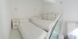 A bed or beds in a room at Duomo Inn