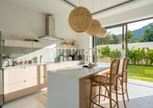 a kitchen with a counter and some chairs in it at Balinese Pool-Villa Kolada, 4 Beds, Maenam, Koh Samui in Ban Tai