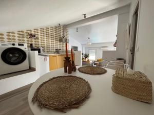 a kitchen with a white counter top with a microwave at Los Naranjos Eco Home Apartamentos Rurales in Casas de Millán