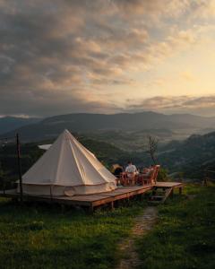 a couple of people sitting in chairs next to a tent at Alereks Mountain Camping in Dsegh