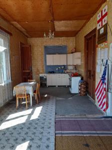 a kitchen with a table and an american flag at individual low-budget guest-house in Tsqaltubo
