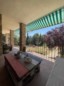 a large patio with a table and a fence at Villa Sanz in Cuenca