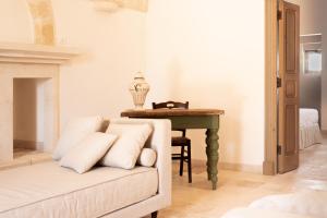 a living room with a couch and a table at Masseria Gorgognolo in Ostuni