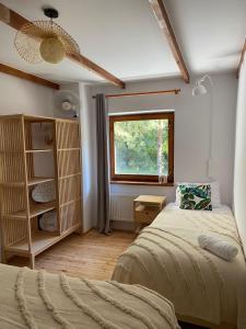 a bedroom with two beds and a window at Villa Lulu Piaseczno in Piaseczno