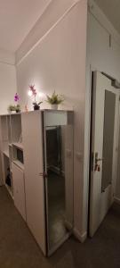 a room with a refrigerator and a counter with potted plants at Hotel Aboukir in Paris