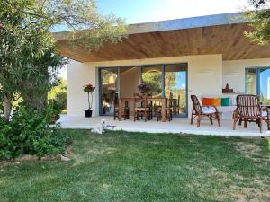 a dog sitting on the grass in front of a house at Newly renovated traditional Sardinian dwelling in Porto Rotondo