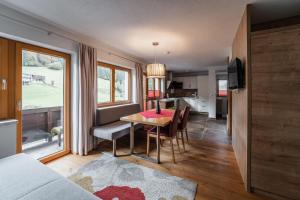 ein Wohnzimmer mit einem Esstisch und einer Küche in der Unterkunft Gästehaus Fohringer in Kelchsau