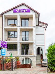 a building with a purple sign on top of it at KOSMYK in Jastrzębia Góra