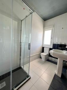 a bathroom with a shower and a toilet and a sink at Casa Lola in Teo