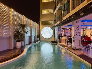 a swimming pool in the middle of a building at Ratri Hotel Phuket Old Town in Phuket