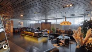 a large living room with couches and chairs at Thingholt by Center Hotels in Reykjavík