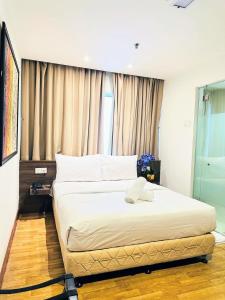 Postel nebo postele na pokoji v ubytování Frenz Hotel Kuala Lumpur