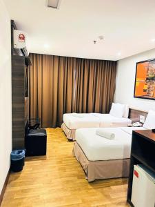 Postel nebo postele na pokoji v ubytování Frenz Hotel Kuala Lumpur