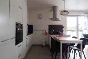 a kitchen with a table and a dining room at A l Orée du Bois in Rimbach-près-Masevaux +12 photos