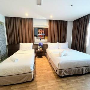 Postel nebo postele na pokoji v ubytování Frenz Hotel Kuala Lumpur