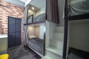 a room with three bunk beds and a staircase at LOFT Hostel in Gyumri