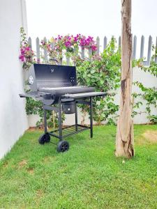 a barbecue grill with a laptop on top of it at Luxury Villa sea view in Agadir