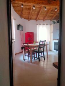 a kitchen with a table and chairs and a red refrigerator at Casa Storta - Cycle Garage CON BICICLETTE in Pisogne +17 photos