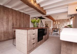 a kitchen with wooden cabinets and a counter top at Luxury Cottage in Peak District near Alton Towers in Stanton