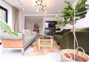 a living room with a couch and a table at Green Cottage Luxury Stay Peak District near Alton Towers in Stanton