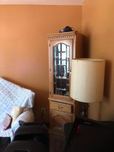 a bedroom with a bed and a dresser and a lamp at Room to share in South Ozone Park