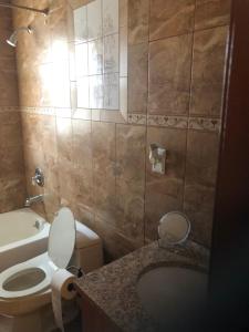 a bathroom with a toilet and a sink at Room to share in South Ozone Park