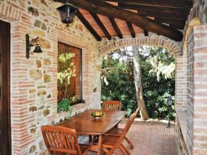 an outdoor patio with a wooden table and chairs at Villa San Martino in Serrazzano