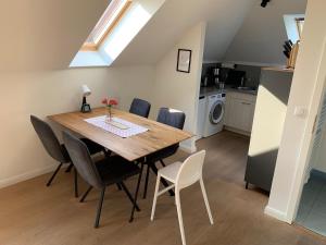 a kitchen and dining room with a table and chairs at FeWo Lust auf Laboe in Laboe