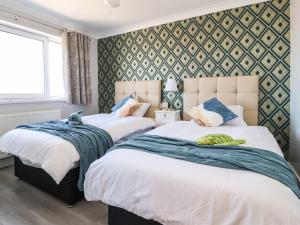 a bedroom with two beds with towels on them at 26 North Promenade in Cleveleys