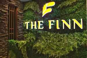 a sign for the firm on the side of a building at The Finn Hotel / เดอะฟินน์โฮเทล in Ban Liap
