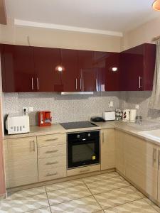 a kitchen with brown cabinets and a black oven at Modern House in Mytilene Center in Mytilene