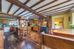 a large kitchen with wooden floors and wooden ceilings at Brookside Manor House in Chirk