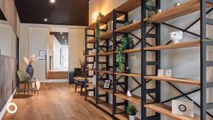 a room with wooden shelves with plants on the wall at Thingholt Hotel Apartments from Center Hotels in Reykjavík