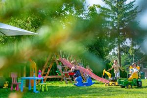 a group of children playing on a playground at Domki na odludziu in Kazimierz Dolny