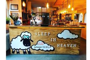 a sign that says sleep in a bakery with a sheep at Sleep in Heaven in Copenhagen