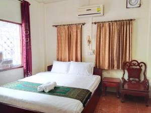 a bedroom with a bed with a stuffed animal on it at Thipphaphone Guesthouse in Pakbeng