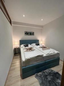 A bed or beds in a room at LUX apartmany Romantika CHOPOK 7, 19
