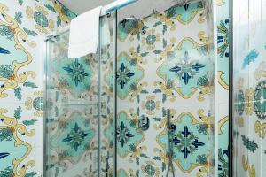 a bathroom with blue and gold wallpaper at Hotel Fontana in Amalfi +37 photos