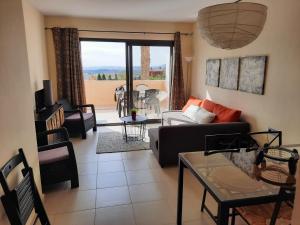 a living room with a couch and a table at Golf Penthouse Valle del Este Vera 116, Las Moreras in Vera