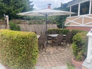 a patio with a table and an umbrella at Spreehotel Spremberg in Spremberg