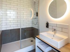 y baño con bañera, lavamanos y ducha. en Ibis Marseille Marignane Technopole, en Marignane