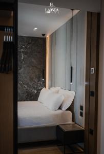 a bedroom with a bed with white pillows at La Onda Hotel Durres in Durrës