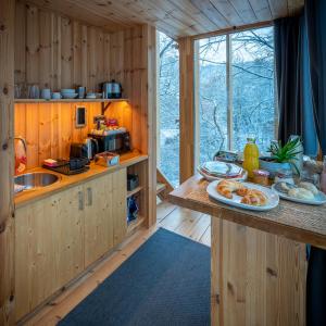 a kitchen with a counter with plates of food on it at TreeHouses Noszvaj in Noszvaj