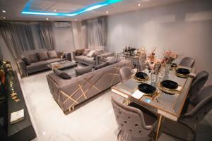 JQ.APARTMENTS في آكرا: غرفة معيشة مع طاولة وأريكة