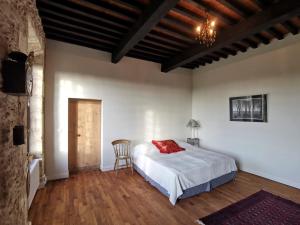 a bedroom with a bed and a chair in it at Château d'Esplavis in Eauze