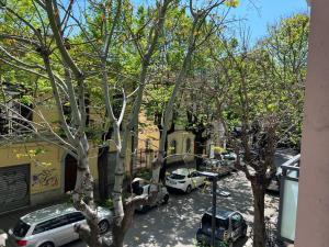 a group of cars parked in a parking lot with trees at CUORE - LUXURY ROOMS in Pescara