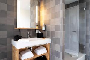 a bathroom with a sink and a shower at greet Hotel Rennes Pace in Pacé +79 photos